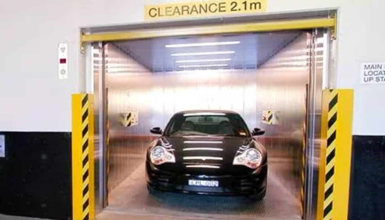 Car entering a parking garage with a clearance sign of 2.1 meters.