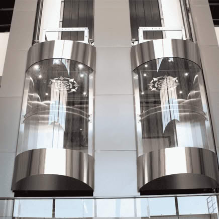 Glass elevators in a modern building interior.