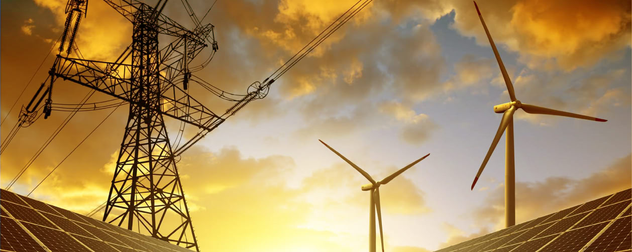 Solar panels, wind turbines, and power lines at sunset.